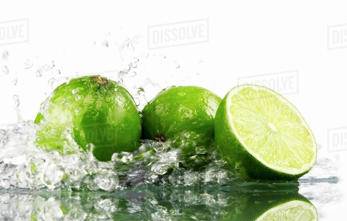 Limes with splashing water Stock Photo Dissolve