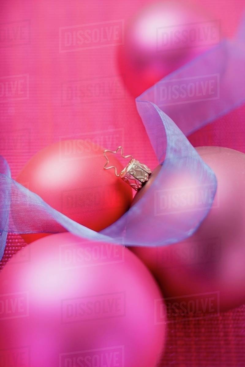 Pink Christmas Baubles With Blue Ribbon Stock Photo Dissolve Pink Christmas Baubles With Blue Ribbon