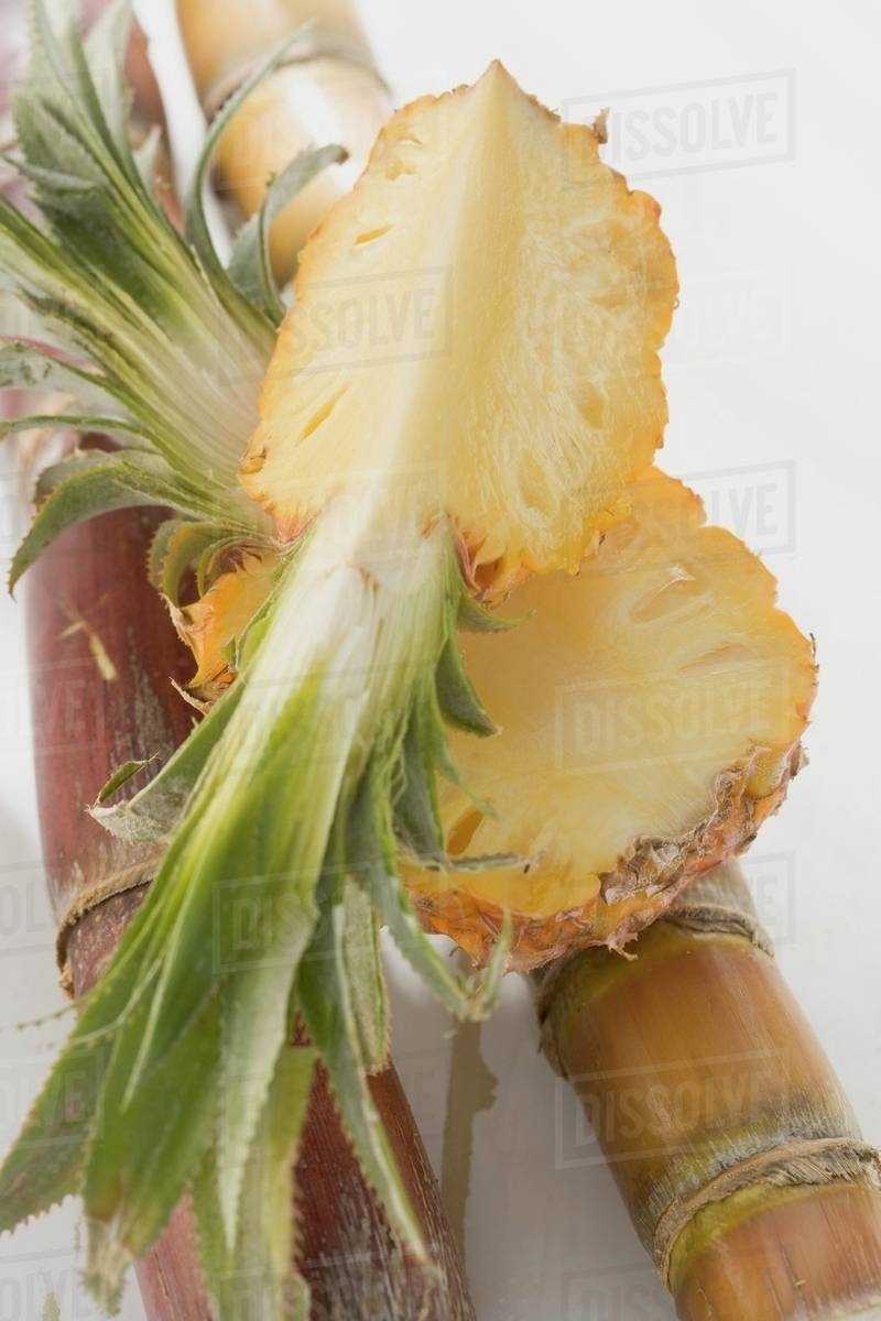Pineapple quarter on half a pineapple Stock Photo Dissolve