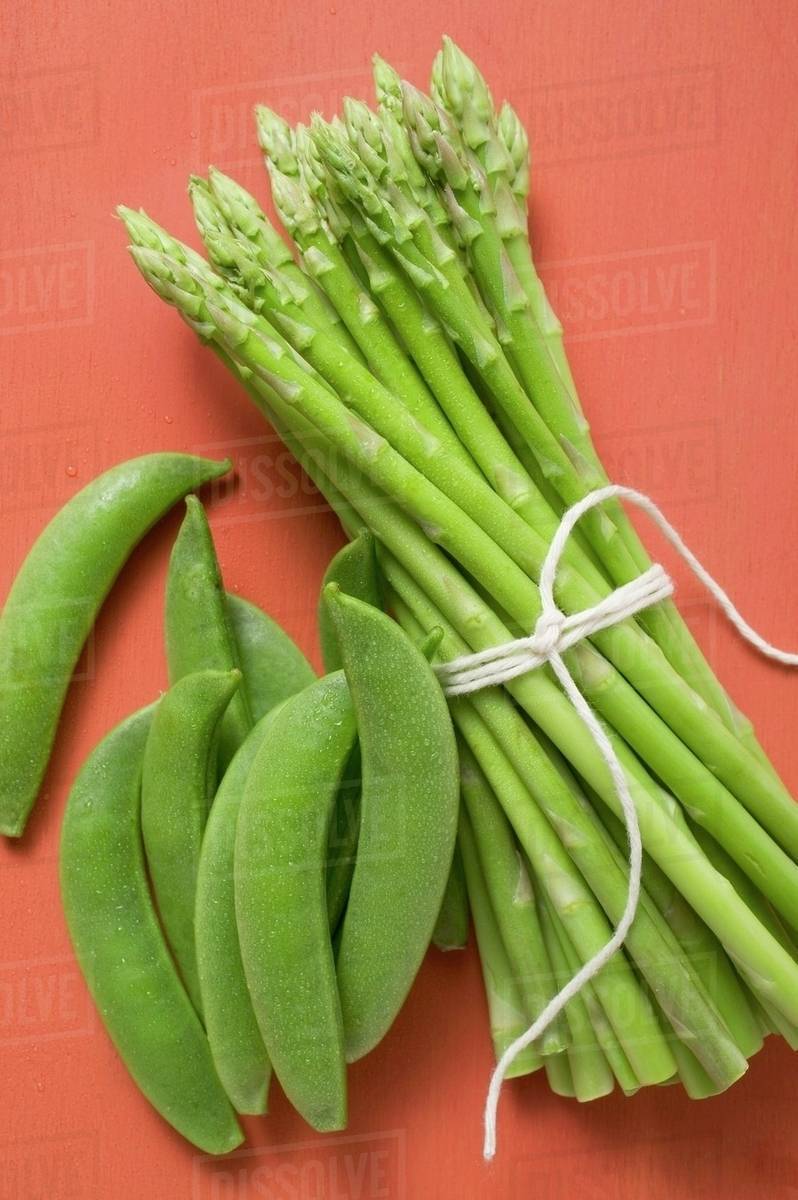 Green asparagus and pea pods Stock Photo Dissolve