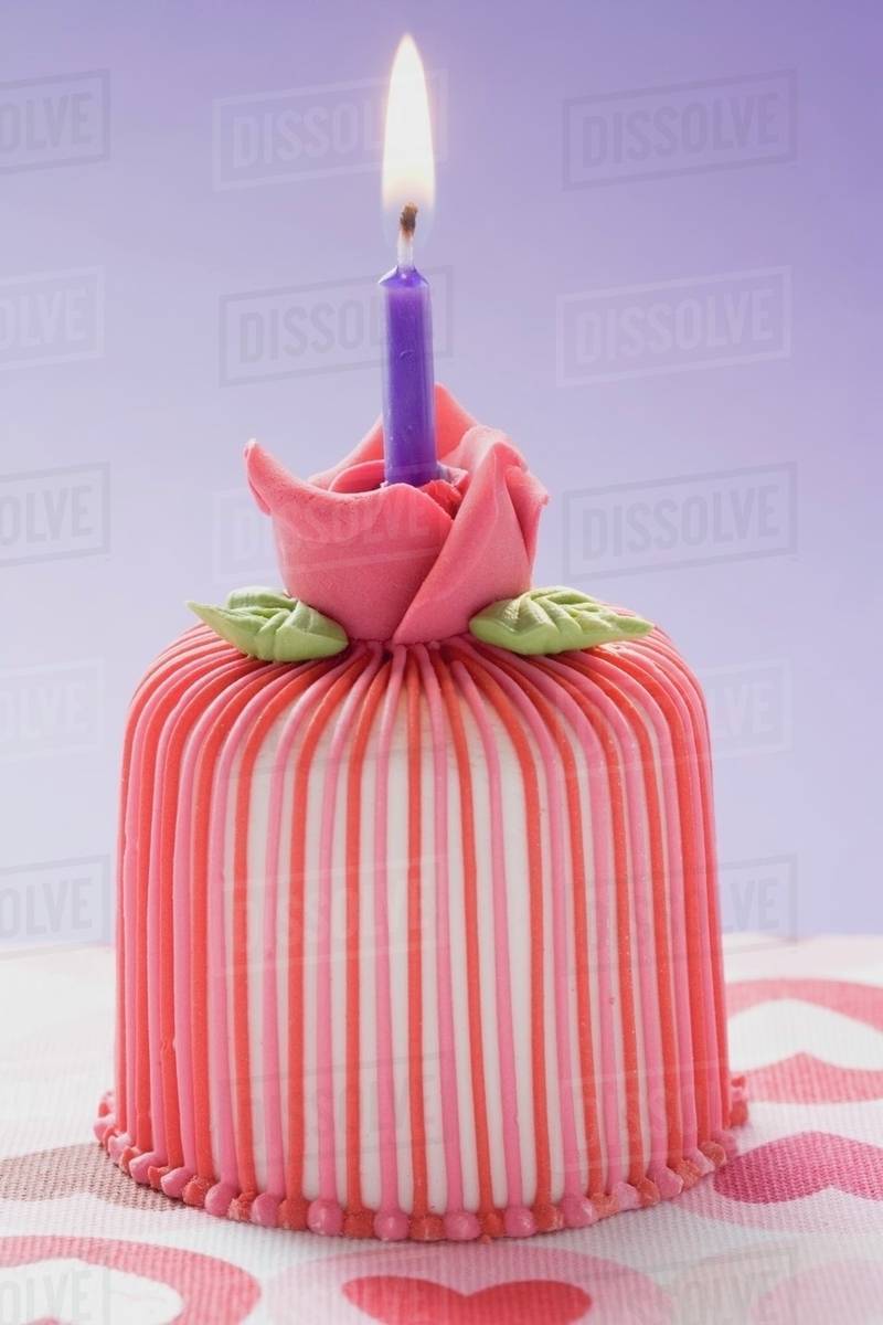 Marzipancovered cake with candle Stock Photo Dissolve