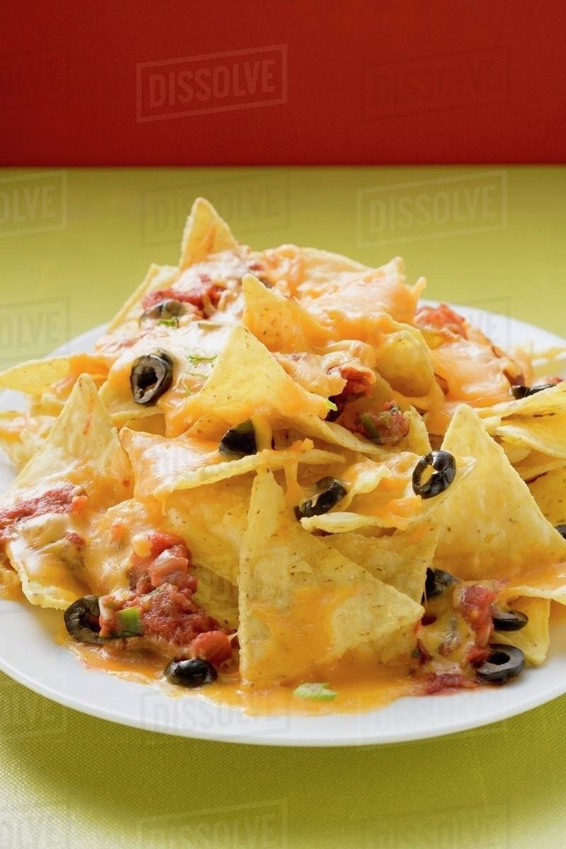 Nachos with melted cheese and olives (Mexico) - Stock Photo - Dissolve