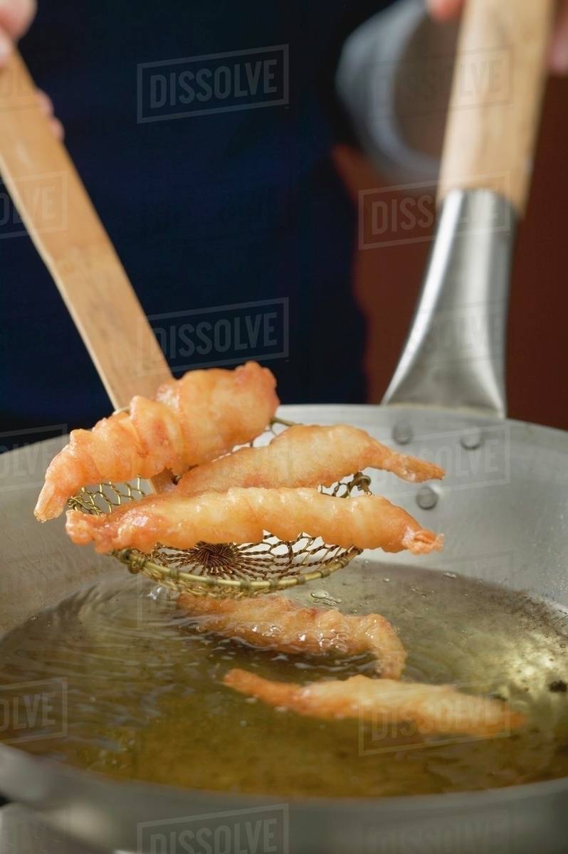 Deepfrying prawns in wok Stock Photo Dissolve