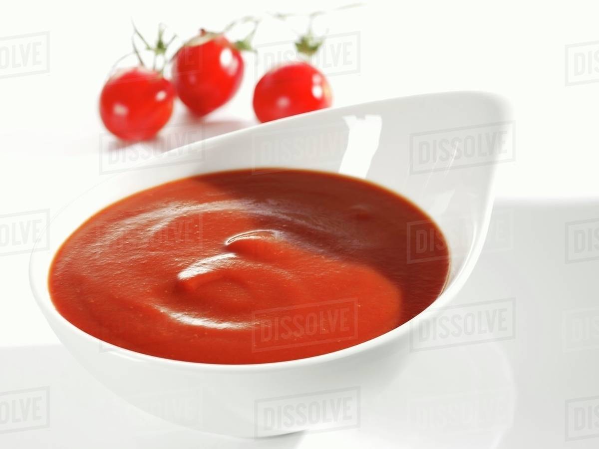 Tomato ketchup in white dish Stock Photo Dissolve