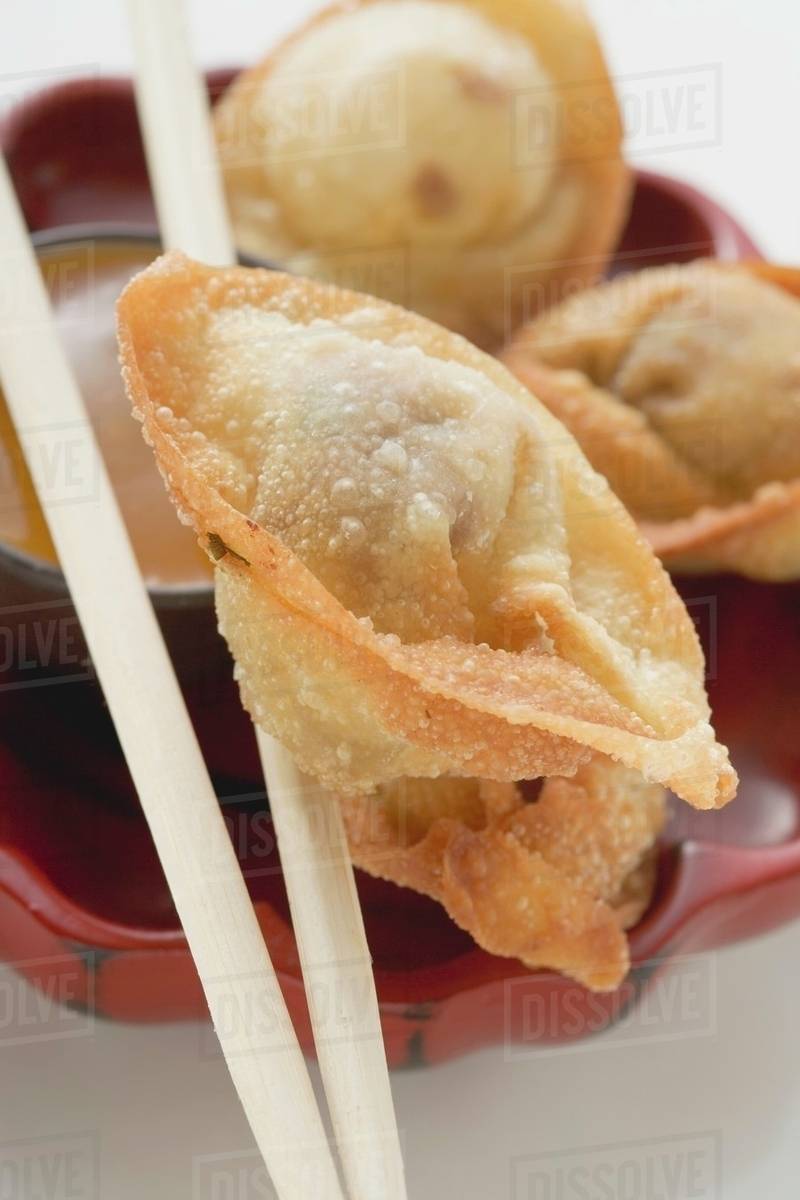Deepfried dim sum on chopsticks (closeup) Stock Photo Dissolve