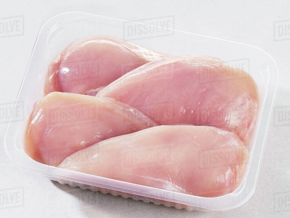 Fresh Chicken Breast Fillets In Plastic Container Stock Photo