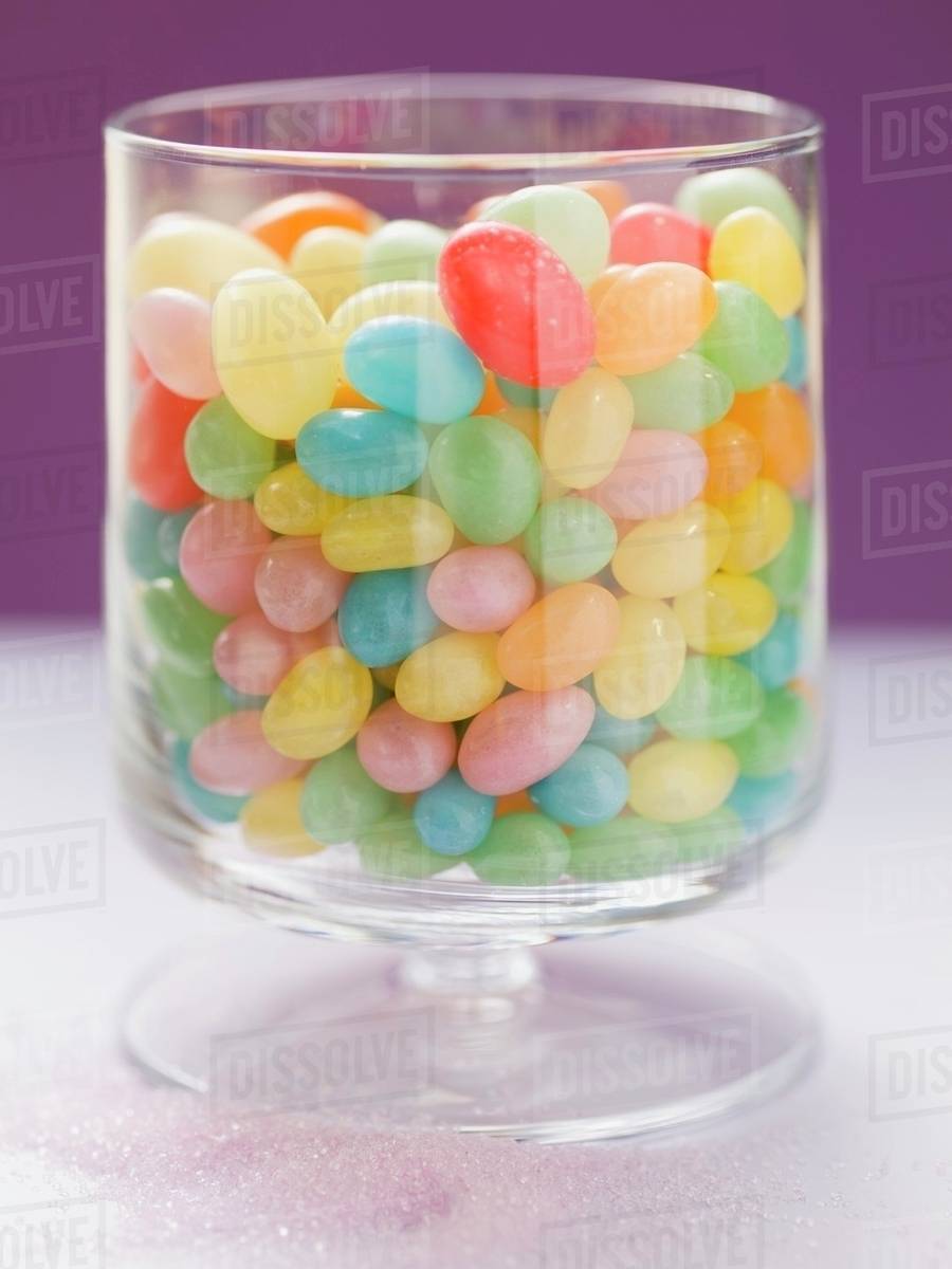 Coloured jelly beans in glass Stock Photo Dissolve