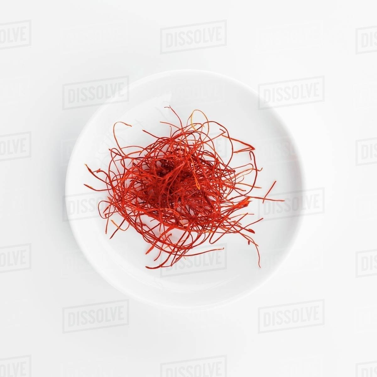 Chilli threads on a white plate - Stock Photo - Dissolve