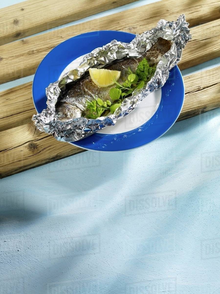 Salmon trout in aluminium foil Stock Photo Dissolve