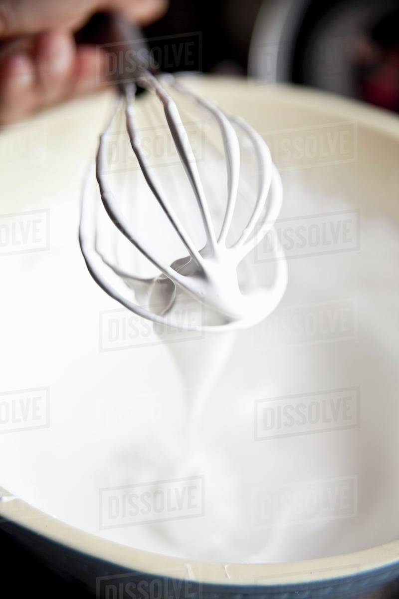Meringue with a whisk Stock Photo Dissolve