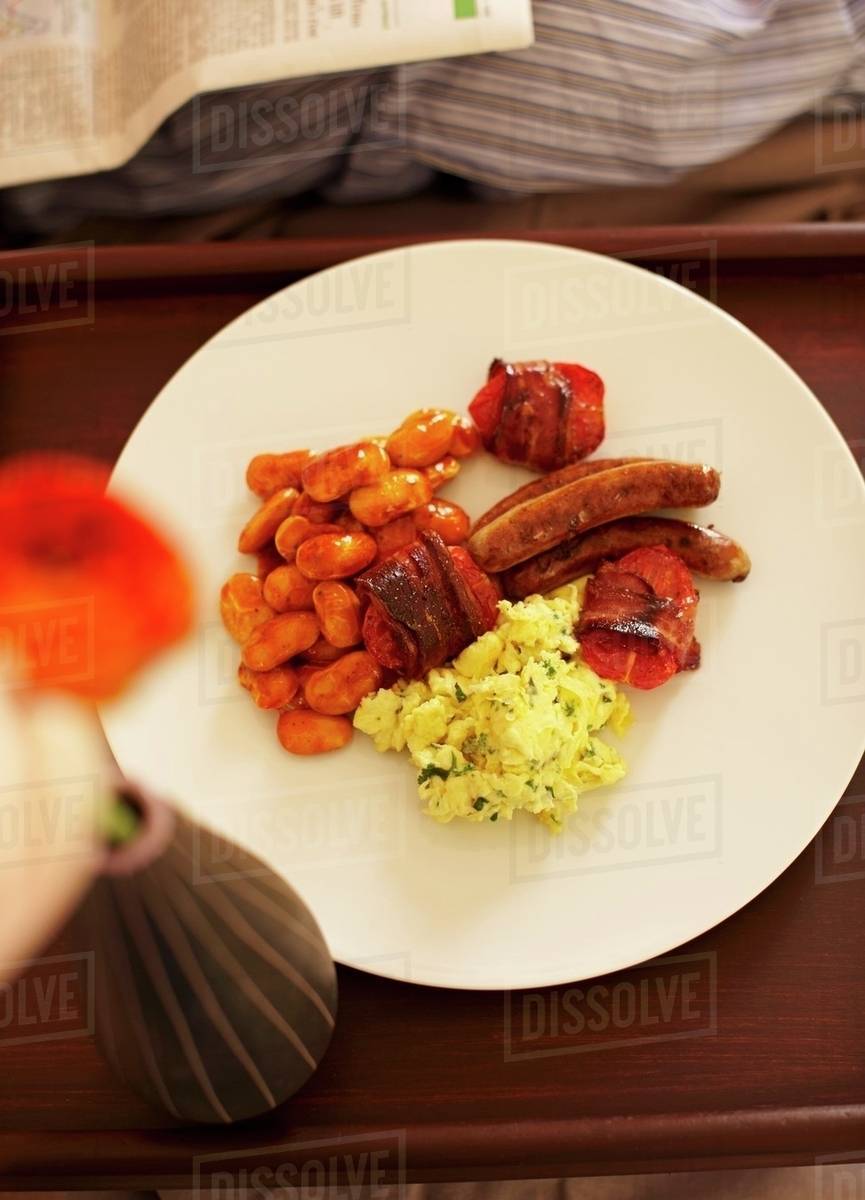 An English Breakfast With Scrambled Eggs Baked Beans Tomatoes Bacon And Sausages Stock Photo Dissolve