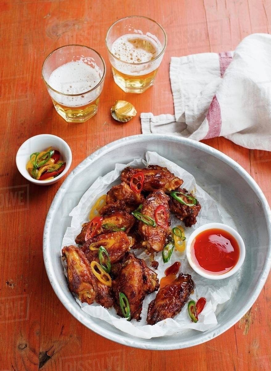 Chicken wings with chilli sauce and beer Stock Photo Dissolve