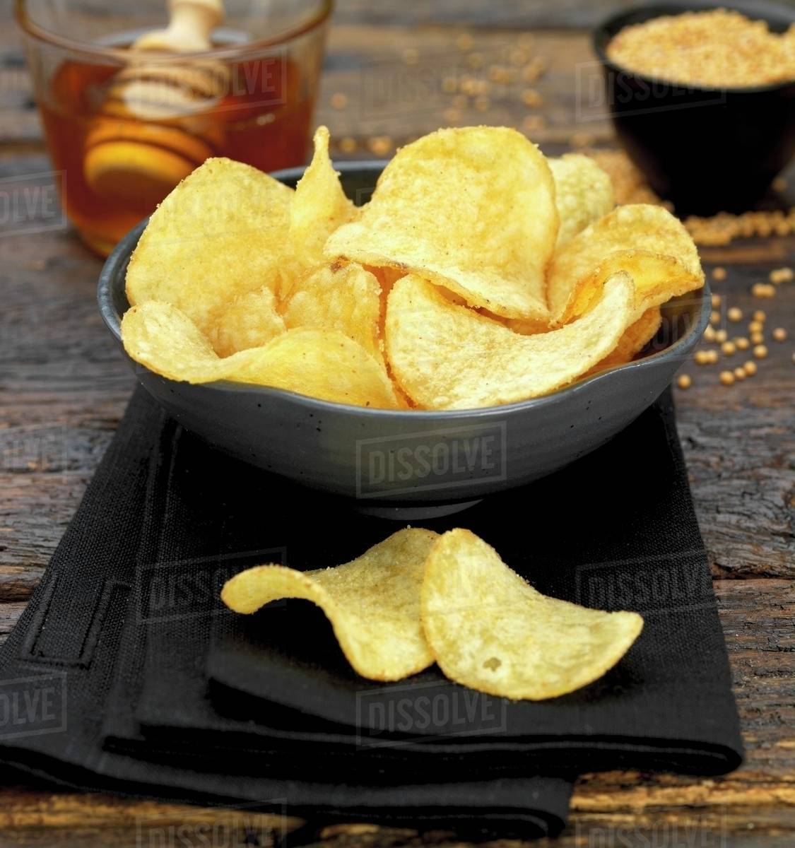 A bowl of honeymustard crisps Stock Photo Dissolve
