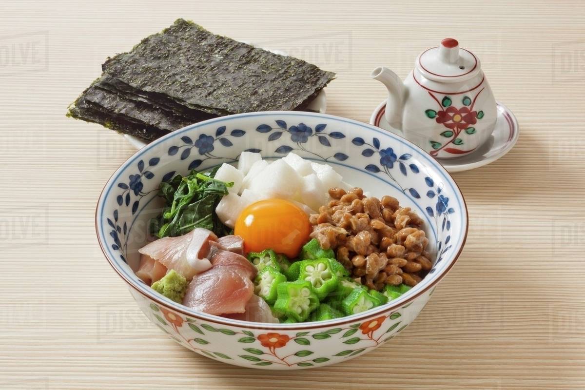 Sticky rice with sashimi, okra, natto and egg yolk (Japan) Stock
