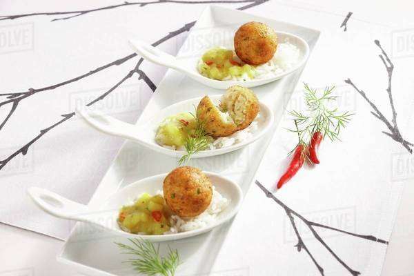 Cod balls in a fruity curry sauce on a bed of rice (Asia) - Royalty ...
