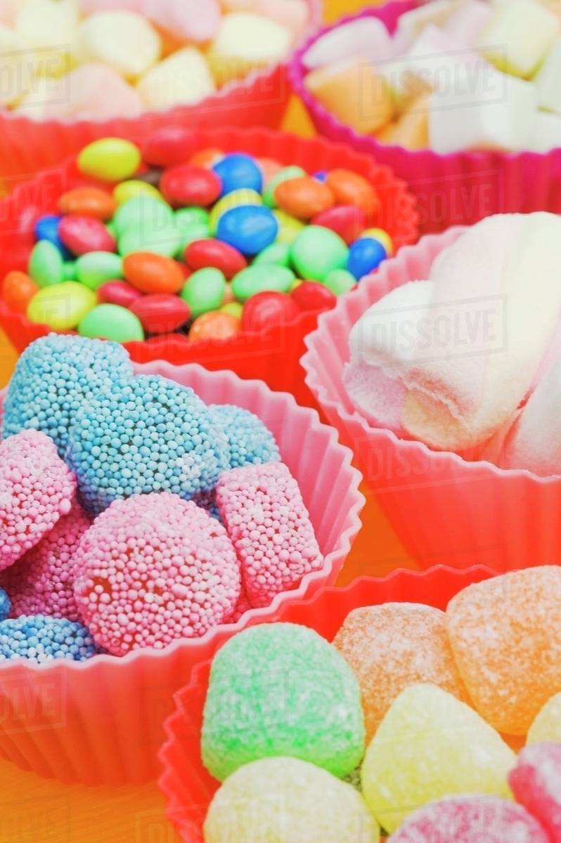 An assortment of sweets: jelly sweets, chocolate beans and marshmallows ...