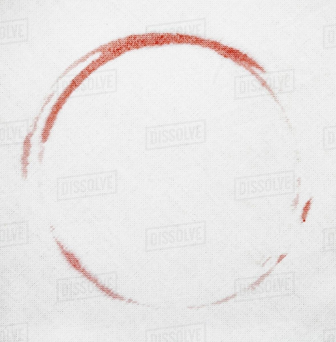 A red wine stain on a white tablecloth Stock Photo Dissolve