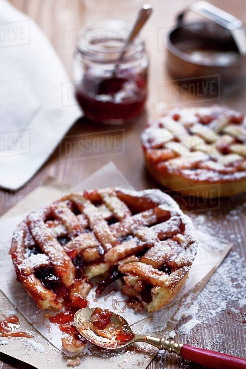 Individual shortcrust pastry tarts with plum jam Stock Photo Dissolve