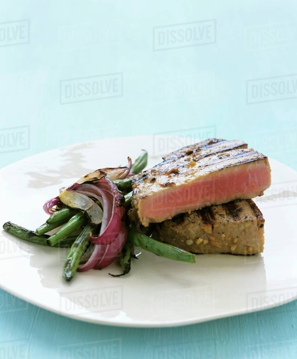 Tuna steak with green beans and red onions Stock Photo Dissolve