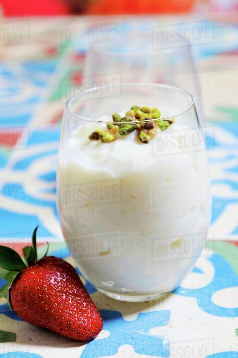 Rice pudding with pistachios (dessert from Egypt) Stock Photo Dissolve
