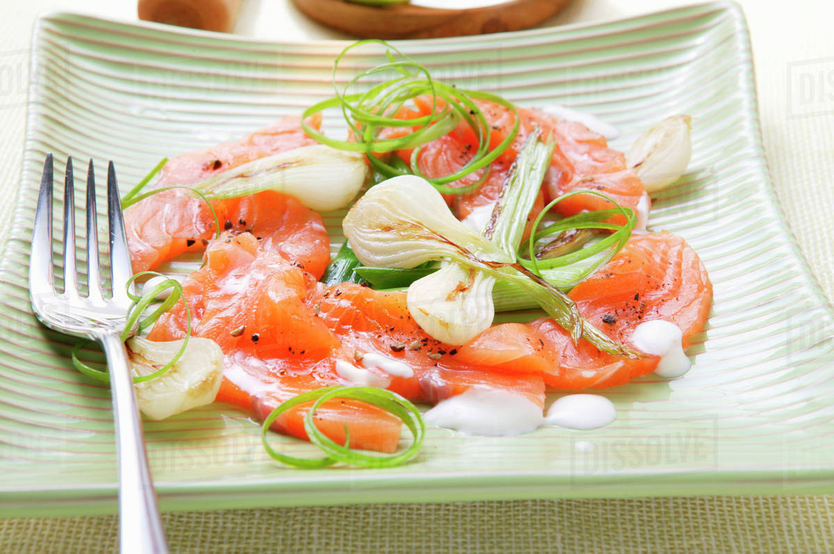 Salmon carpaccio with spring onions Stock Photo Dissolve