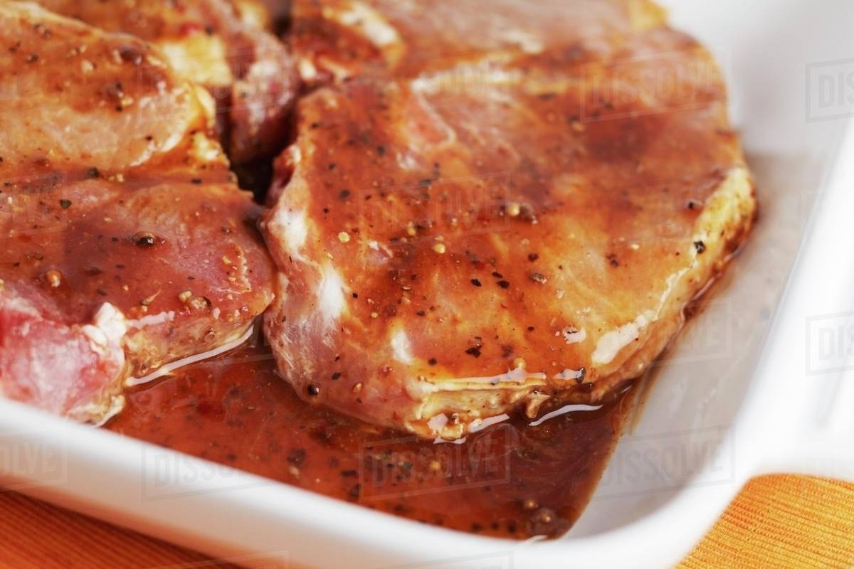 Raw Pork Chops in a Marinade Stock Photo Dissolve