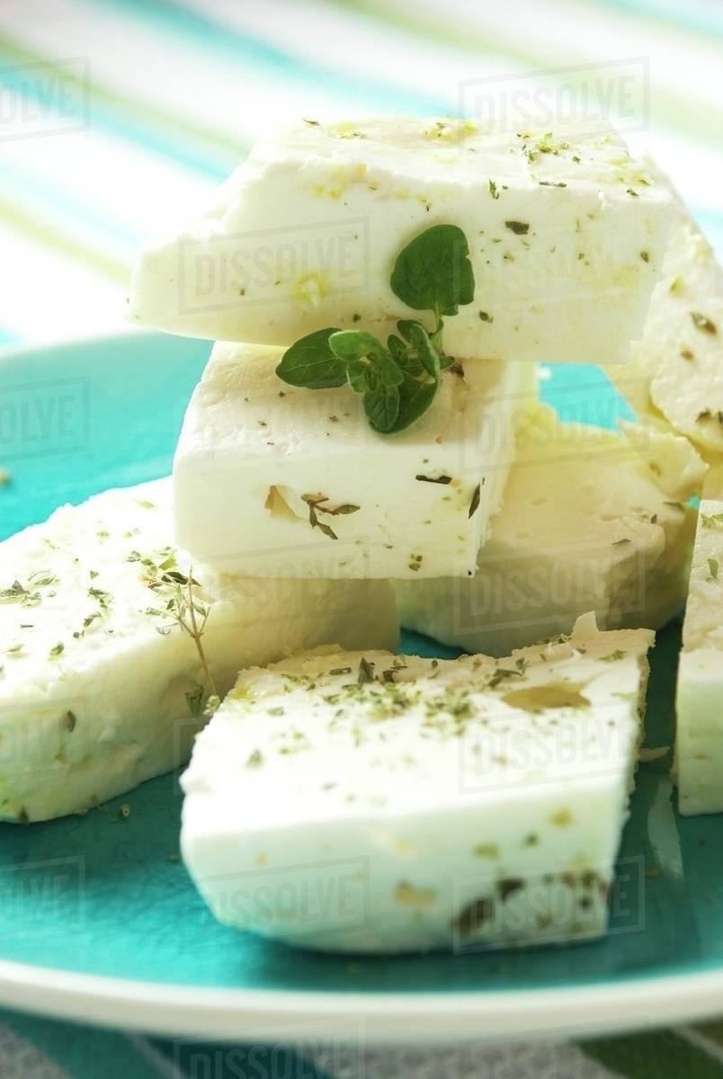 Blocks of Greek Feta Cheese with Dried Oregano on a Blue Plate Stock