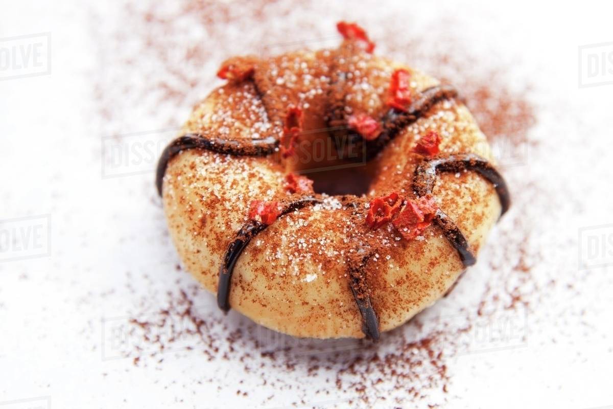 A doughnut with chocolate glaze, cocoa powder and chilli Stock Photo