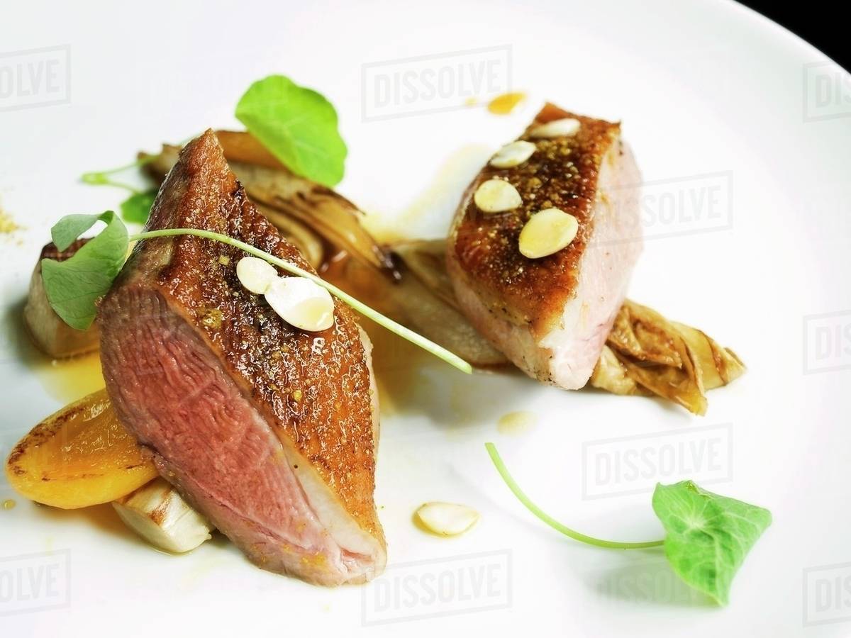 Fried duck breast with apricot sauce and slivered almonds Stock Photo