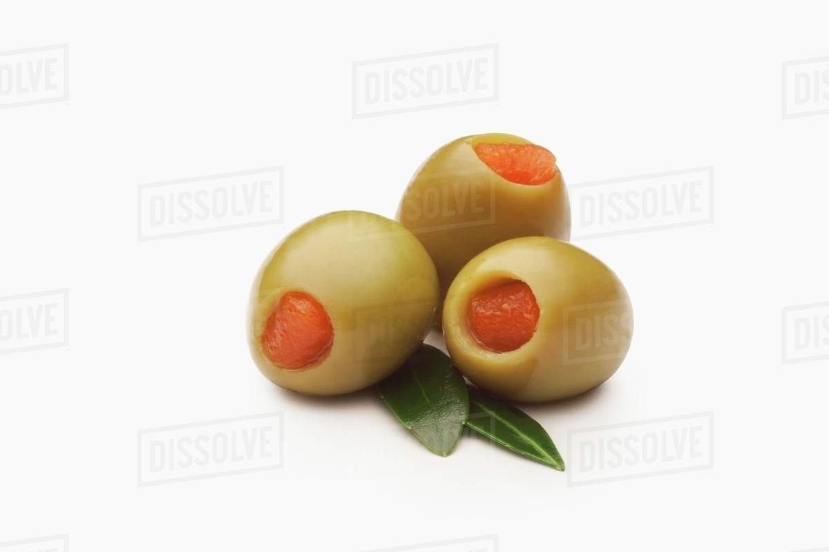 Spanish Green Olives Stuffed with Pimentos; White Background Stock