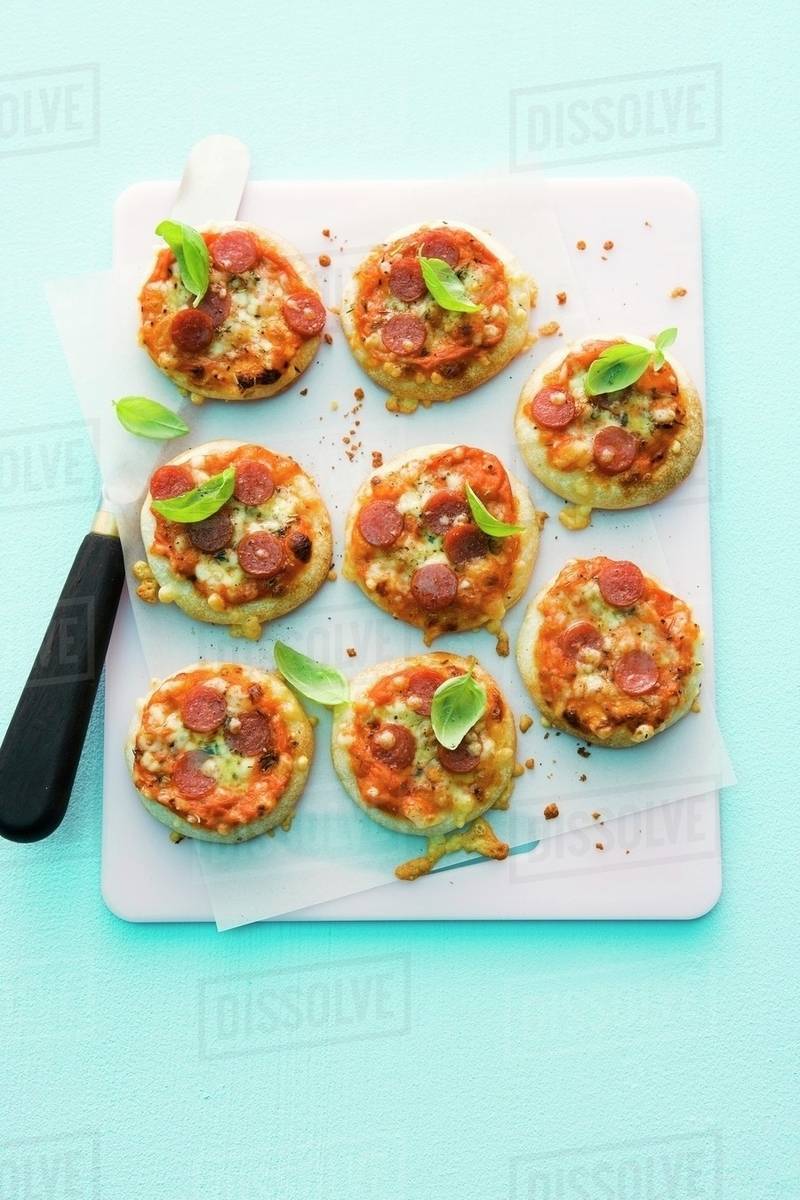 Minipizzas with salami Stock Photo Dissolve