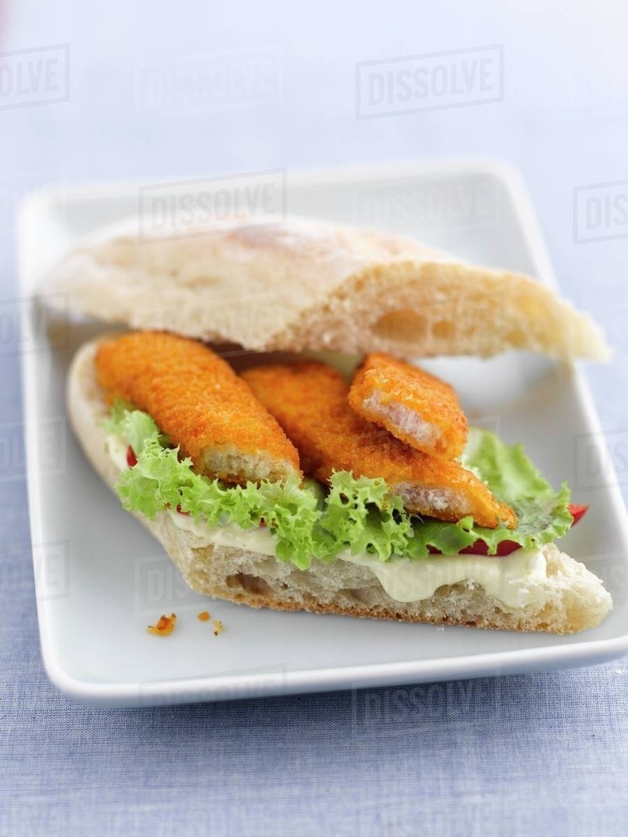 A fish finger sandwich with lettuce and mayonnaise Stock Photo Dissolve
