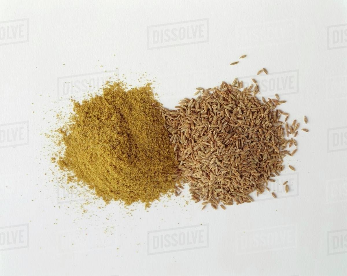 Cumin, whole and ground Stock Photo Dissolve