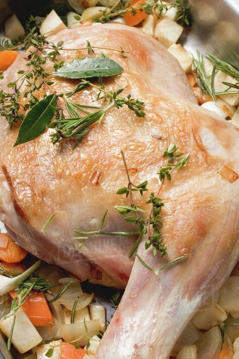 Browned leg of lamb ready for braising Stock Photo Dissolve