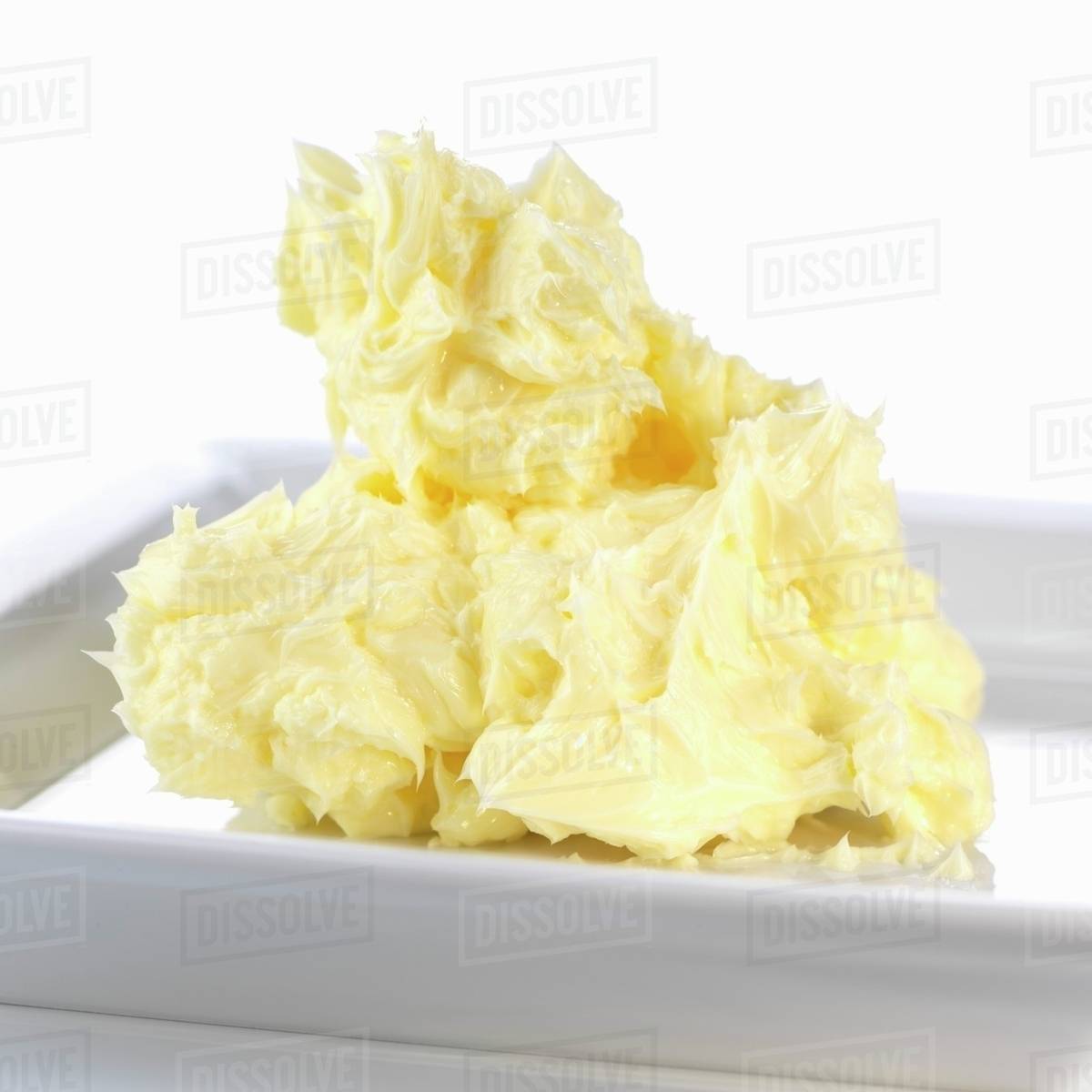 Soft butter on plate Stock Photo Dissolve