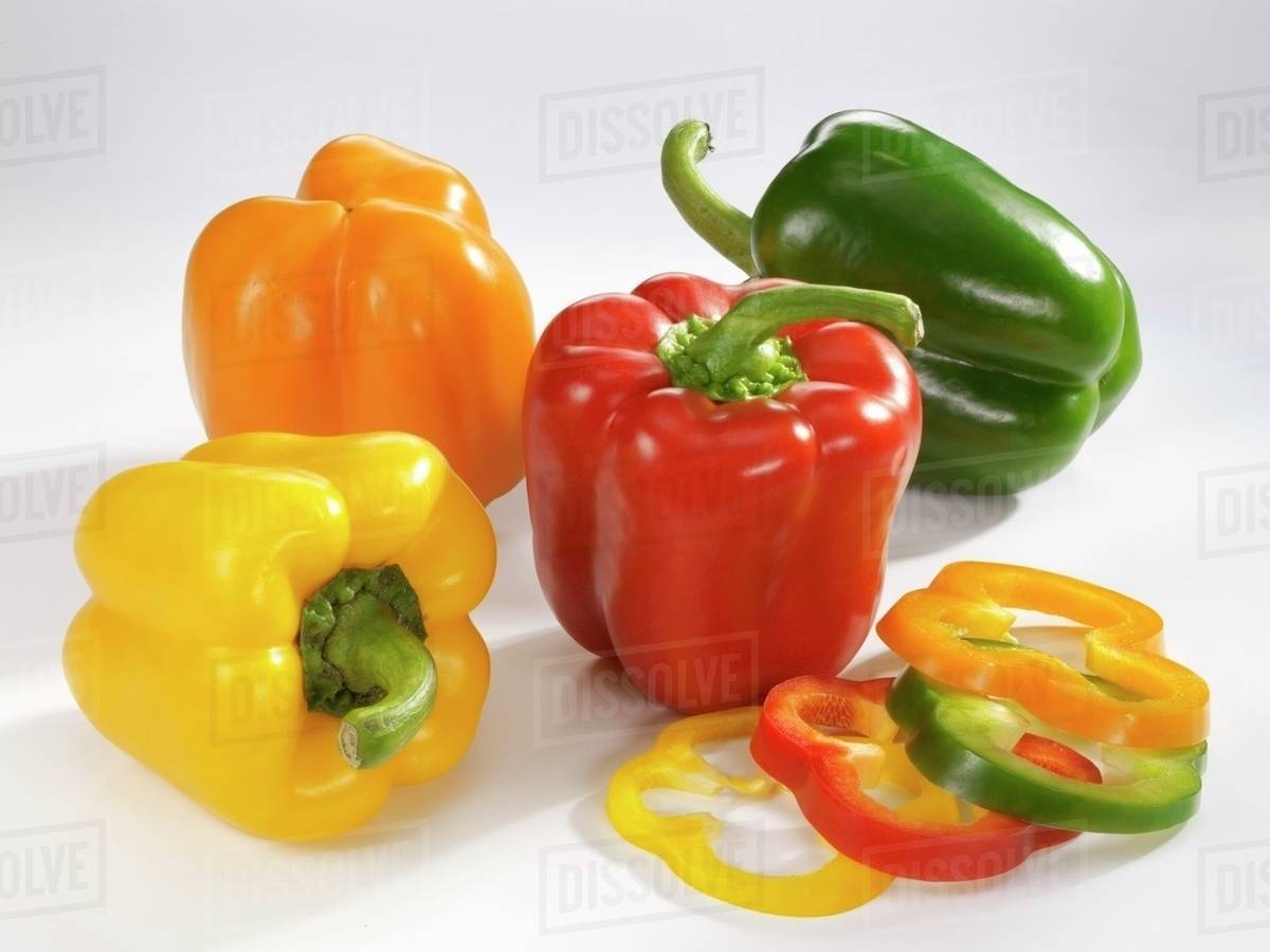 Red, green, yellow and orange peppers Stock Photo Dissolve