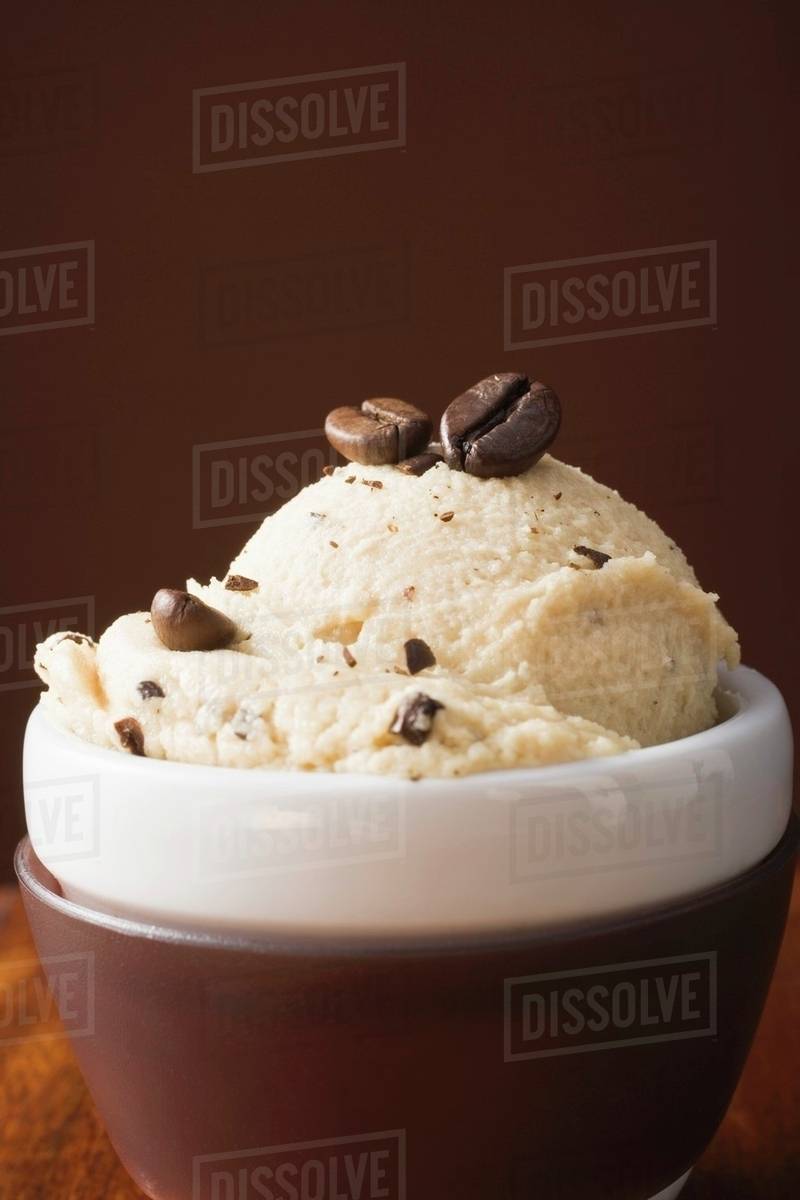 Stracciatella ice cream with coffee beans in dish Stock Photo Dissolve