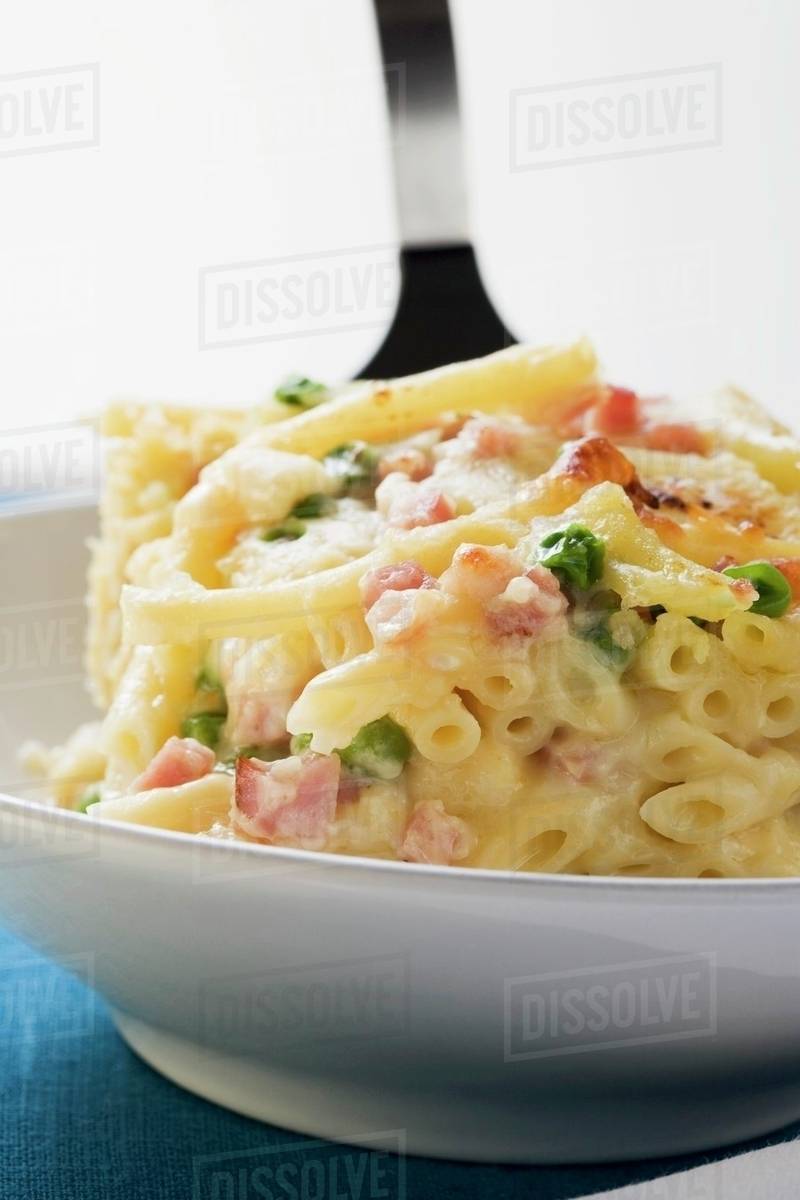 Macaroni bake with ham and peas Stock Photo Dissolve
