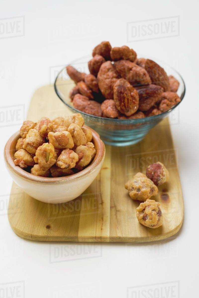 Assorted nuts to nibble in bowls Stock Photo Dissolve