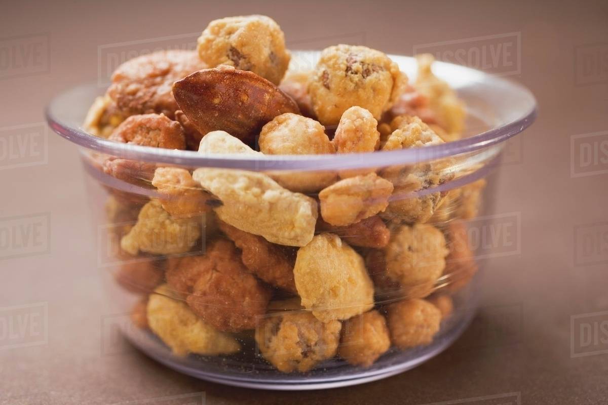 Mixed nuts to nibble in glass bowl Stock Photo Dissolve