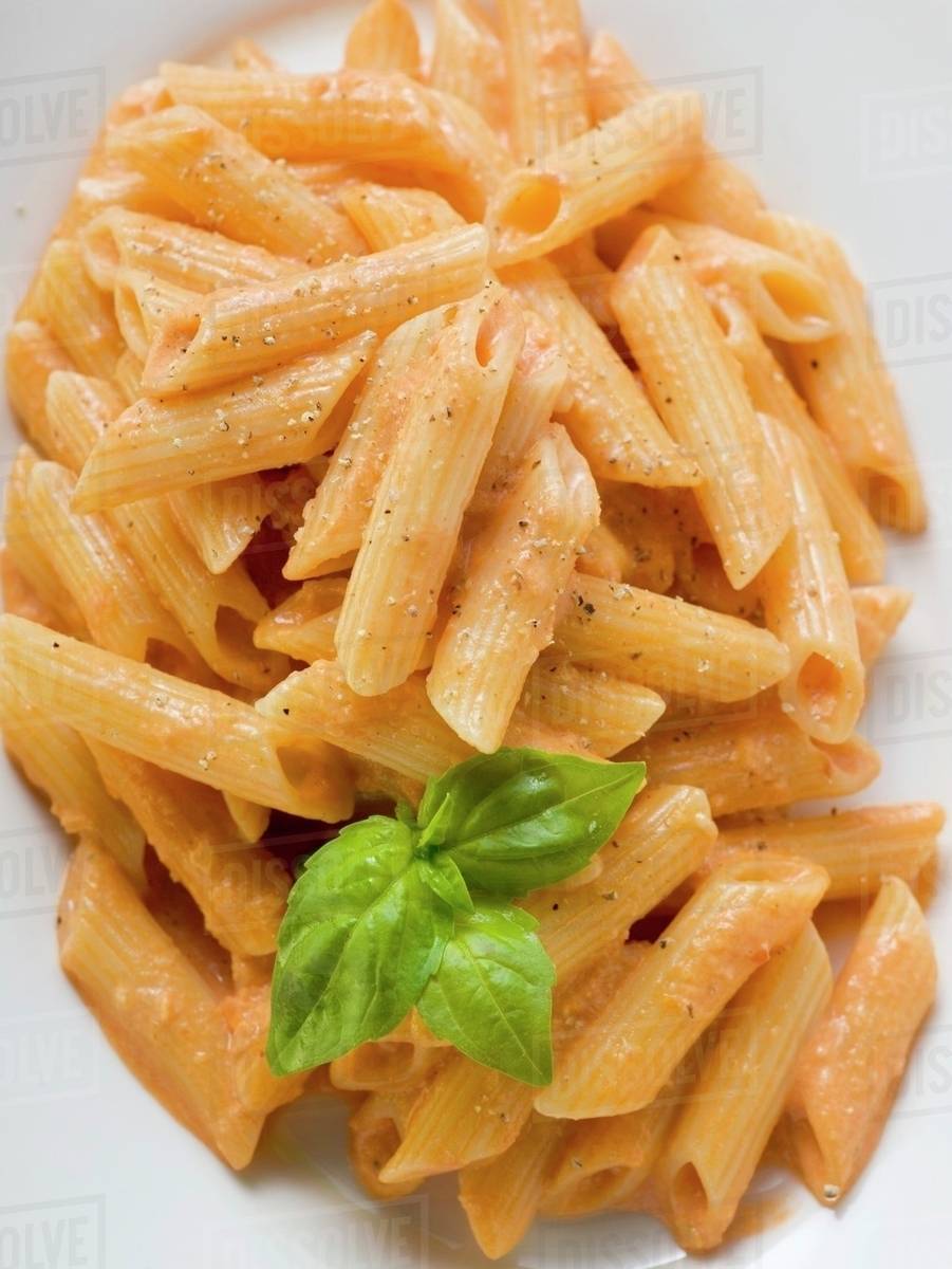 Penne with tomato cream sauce Stock Photo Dissolve