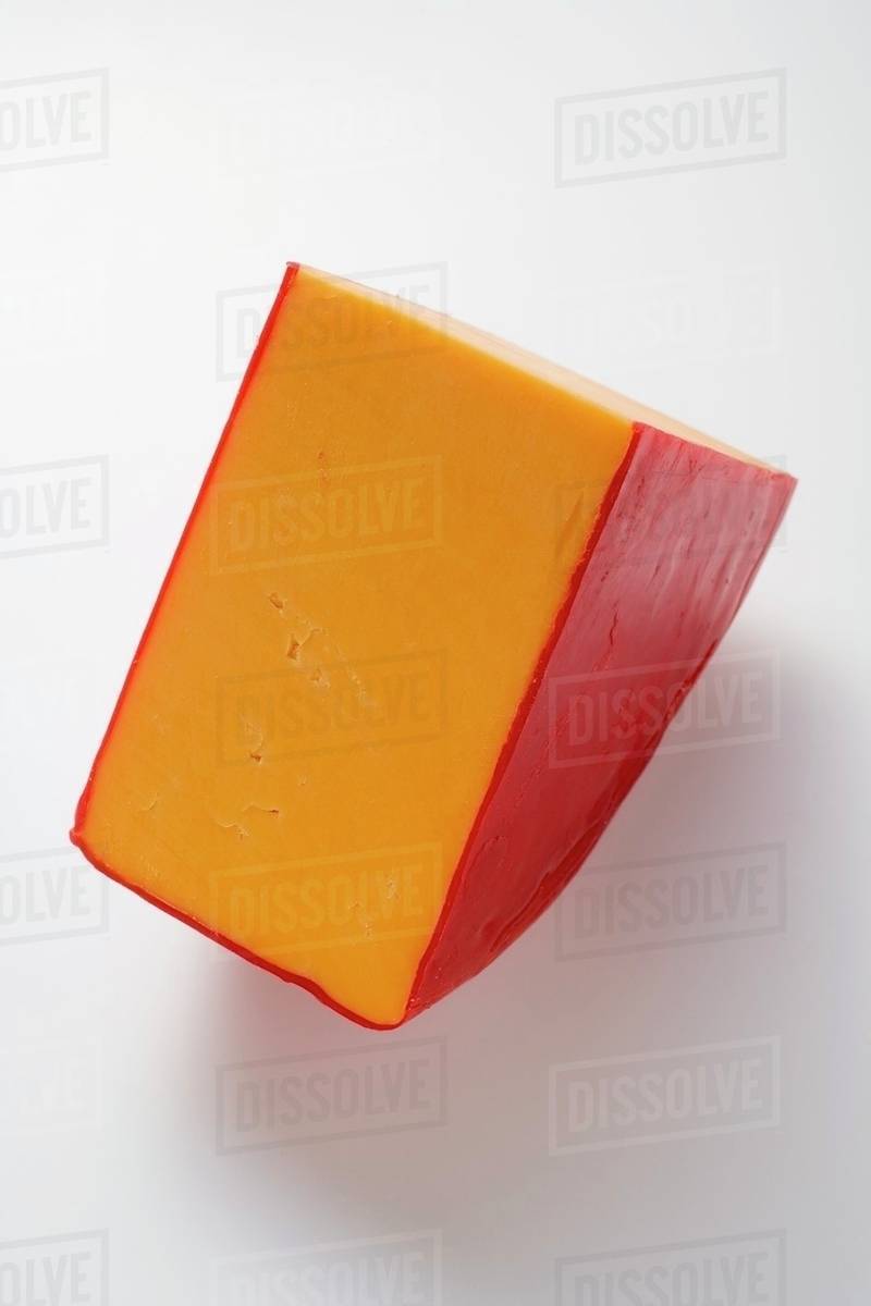 Wedge of Cheddar cheese Stock Photo Dissolve