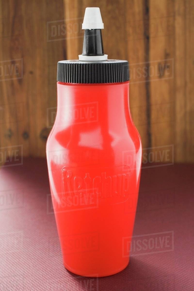 Ketchup in red bottle Stock Photo Dissolve