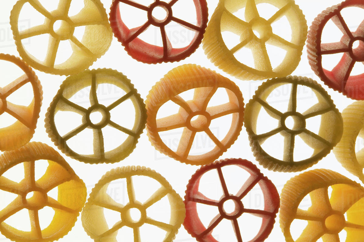 Coloured pasta wheels Stock Photo Dissolve