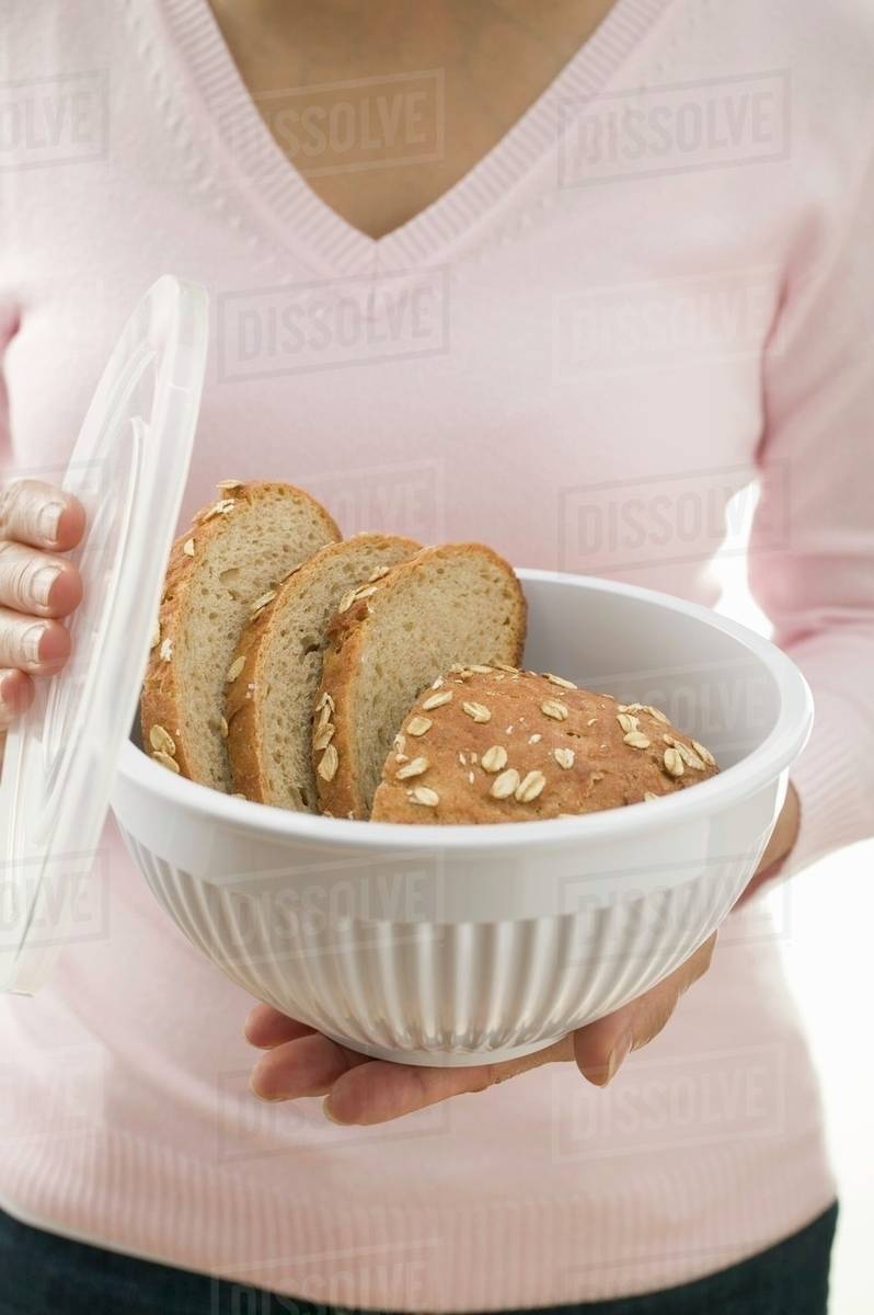 Woman Holding Oat Bread In Food Storage Container Stock Photo