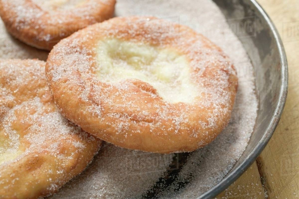 Auszogene (Bavarian doughnuts) in frying pan Stock Photo Dissolve