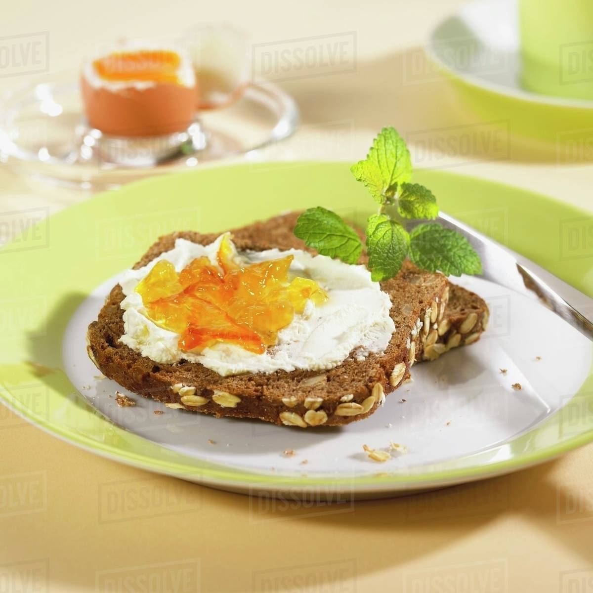 Wholegrain rye bread with quark and marmalade & boiled egg Stock