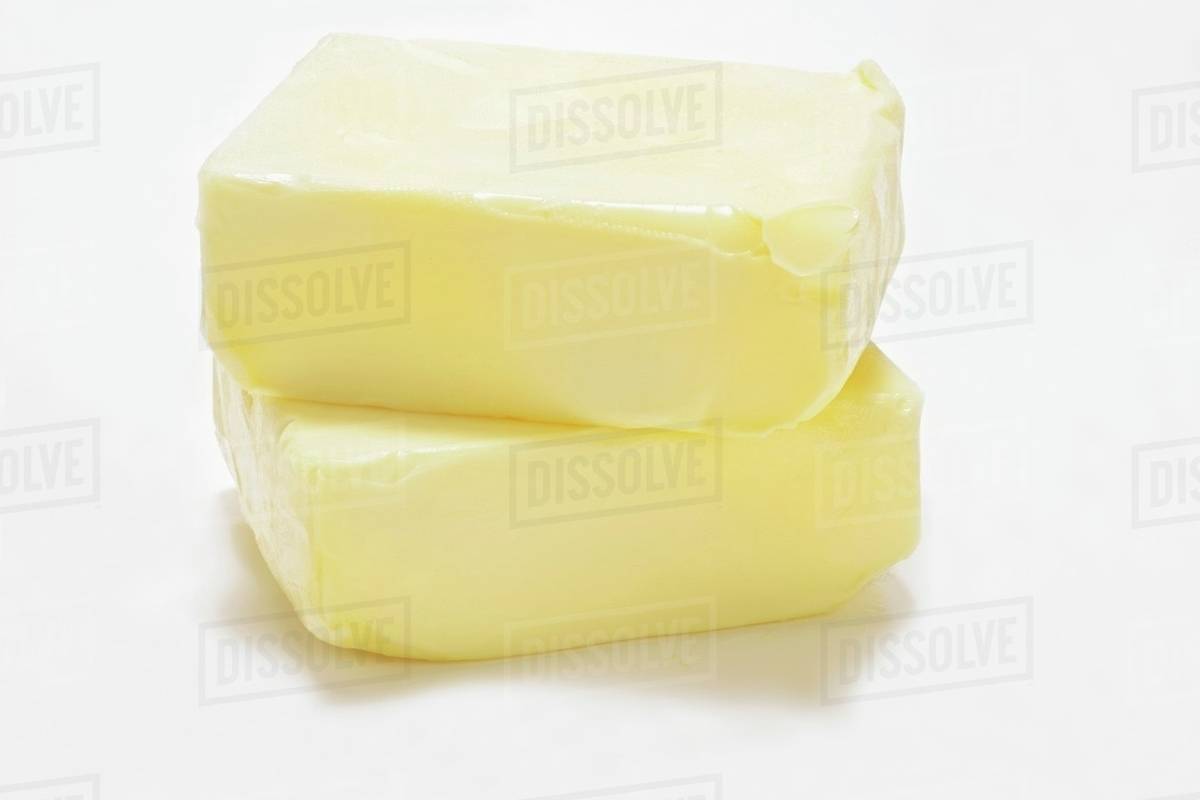 Two blocks of butter, one on top of the other Stock Photo Dissolve