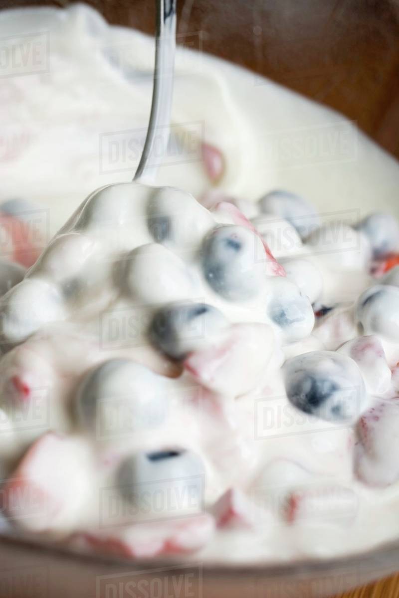Mixing quark cream with berries Stock Photo Dissolve