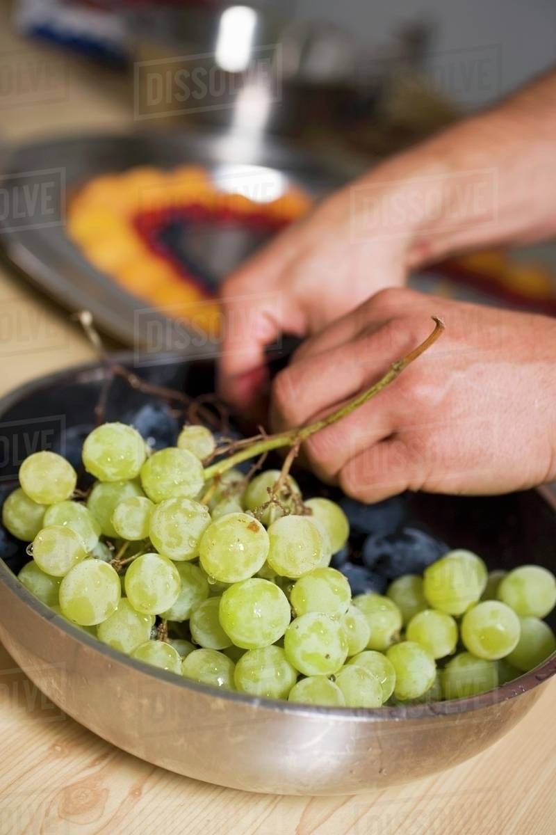 Removing grape stalks Stock Photo Dissolve